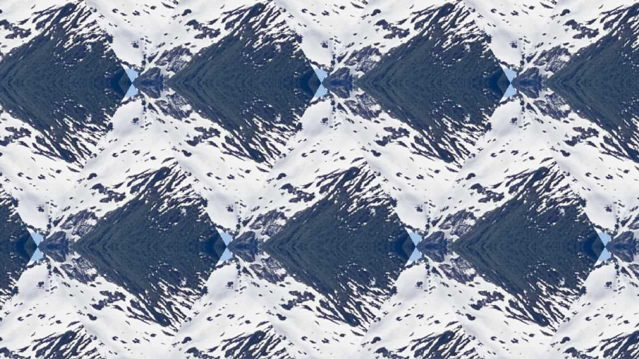 Image of mountain with the center triangle copied in trianglular tiling and flipped triangles are verical mirrors of the above triangle